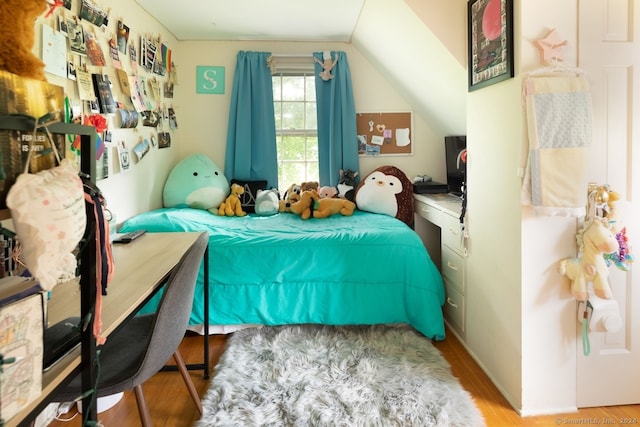 bedroom featuring vaulted ceiling and hardwood / wood-style floors