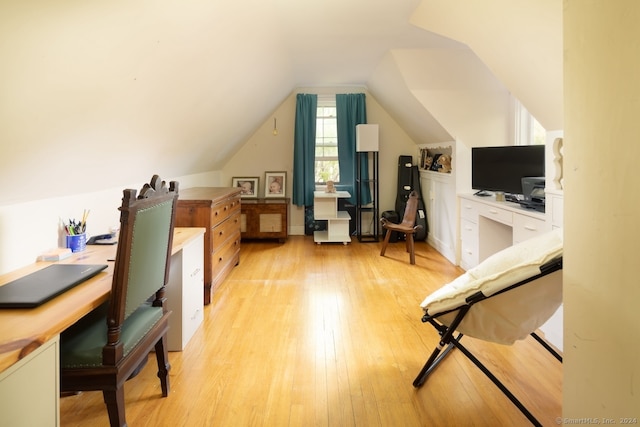 home office featuring vaulted ceiling and light hardwood / wood-style floors