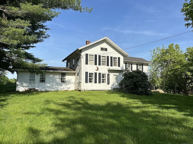 rear view of house with a lawn