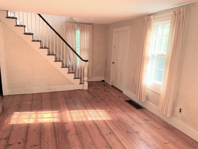 foyer entrance with hardwood / wood-style floors and a wealth of natural light