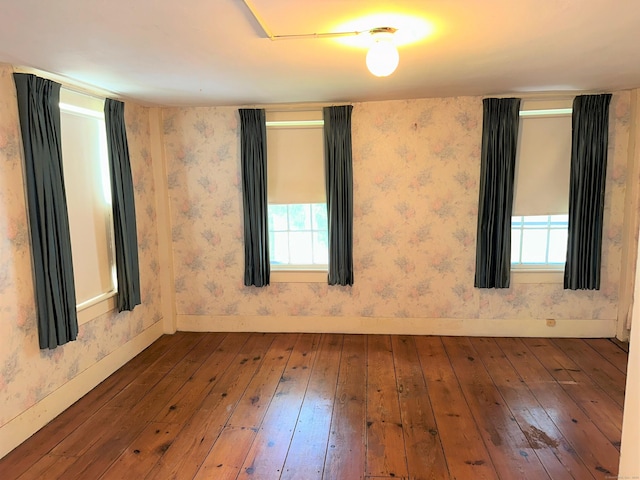 empty room featuring hardwood / wood-style flooring and plenty of natural light