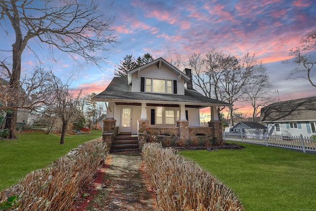 view of front of house featuring a yard and covered porch