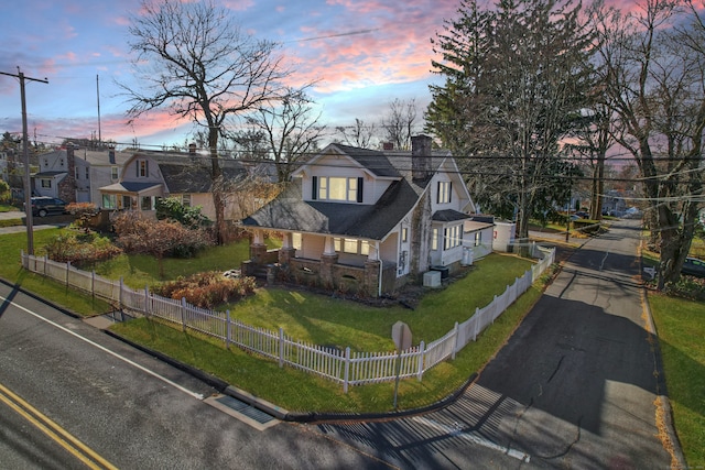 view of front of property featuring central AC unit and a lawn