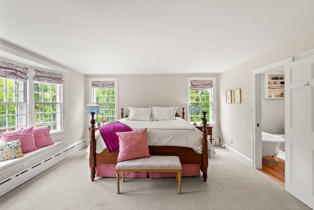 bedroom featuring carpet and a baseboard radiator