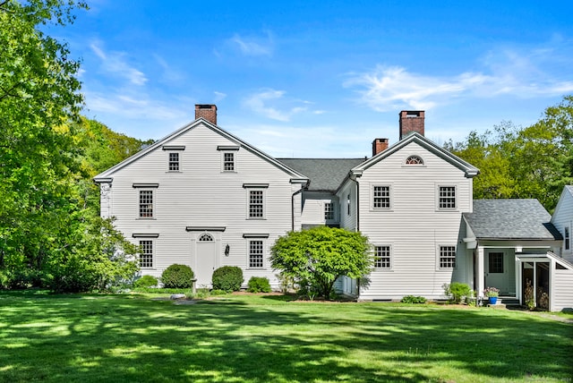 rear view of house with a lawn