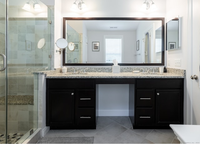 bathroom with tile floors, dual bowl vanity, and an enclosed shower