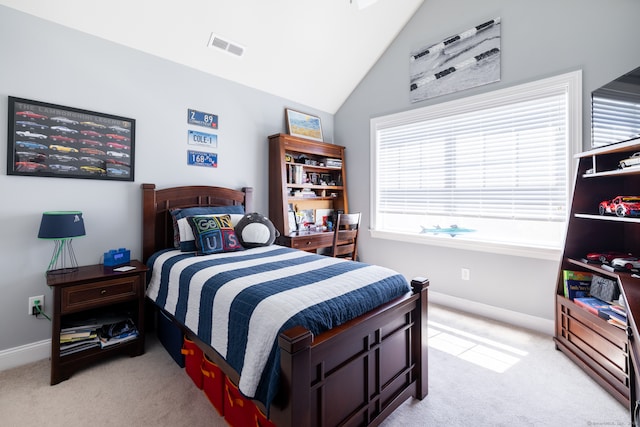 carpeted bedroom with vaulted ceiling