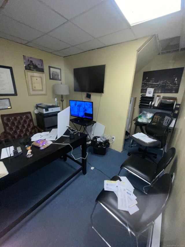 office space with a paneled ceiling