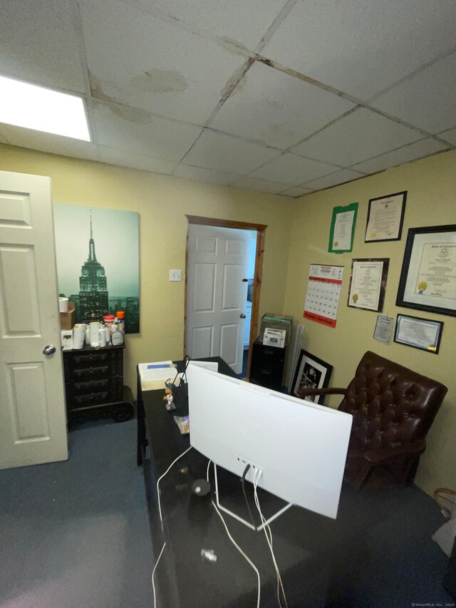 office area with a paneled ceiling