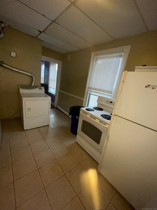 kitchen featuring a baseboard radiator, a paneled ceiling, washer / clothes dryer, white appliances, and light tile floors