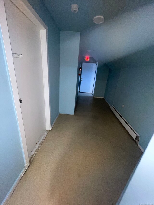 corridor with tile flooring and a baseboard radiator