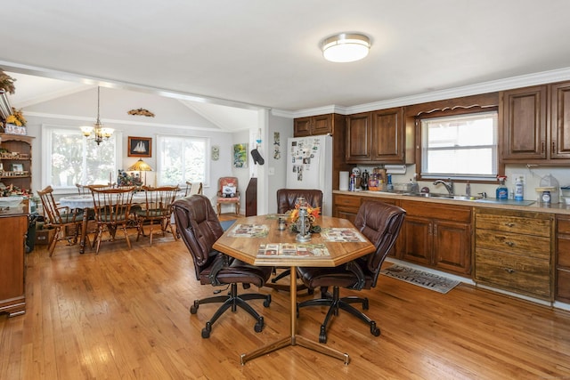 dining room featuring a chandelier, light hardwood / wood-style floors, and plenty of natural light