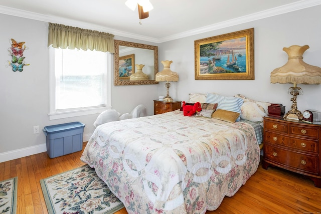 bedroom featuring crown molding, hardwood / wood-style floors, and ceiling fan