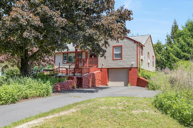 view of front of house featuring a wooden deck and a garage