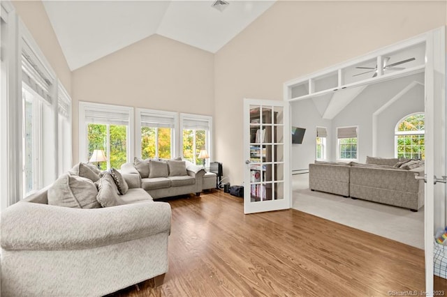 living room featuring ceiling fan, french doors, high vaulted ceiling, and wood-type flooring