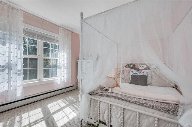 carpeted bedroom featuring baseboard heating