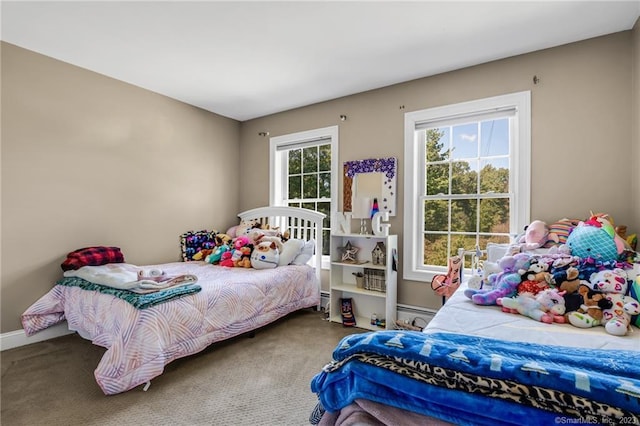 bedroom featuring a baseboard heating unit and carpet