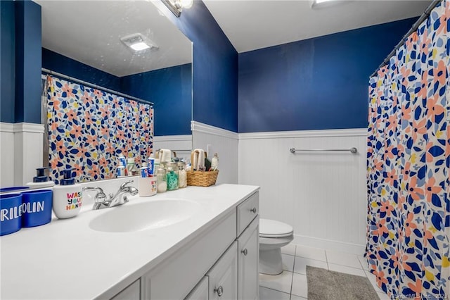 bathroom with vanity, toilet, tile patterned floors, and curtained shower