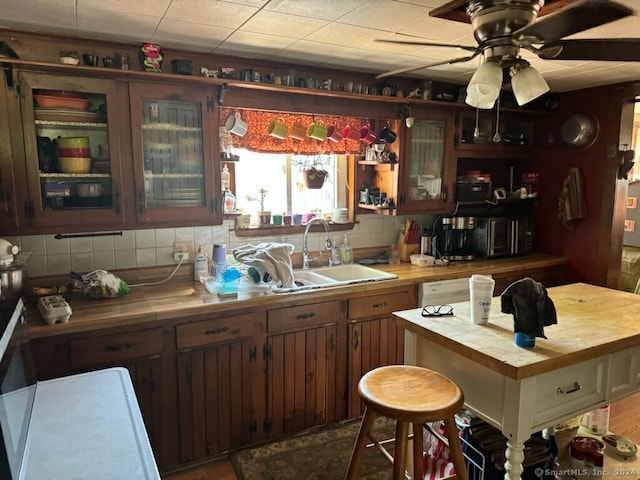 kitchen featuring ceiling fan, sink, tasteful backsplash, and tile countertops