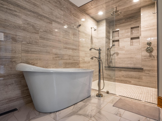 bathroom with separate shower and tub