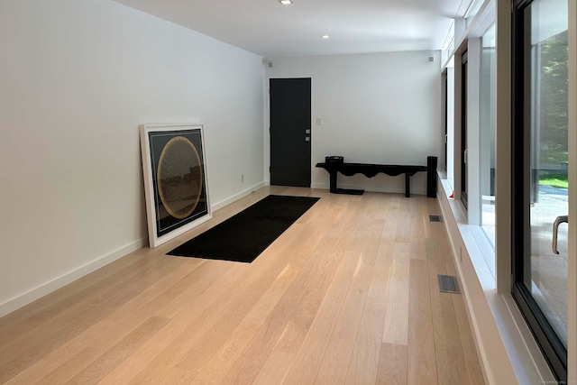 workout room with light hardwood / wood-style flooring