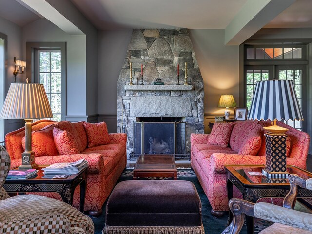 living room with a stone fireplace