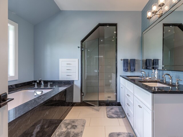 bathroom featuring vanity, vaulted ceiling, tile patterned floors, and plus walk in shower