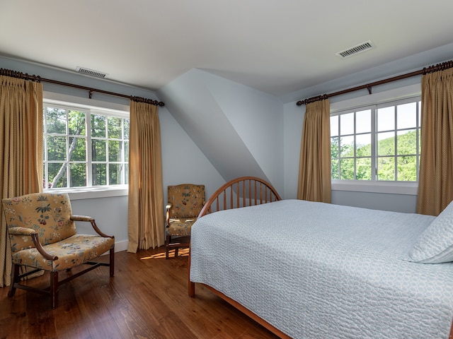 bedroom with dark hardwood / wood-style floors and vaulted ceiling