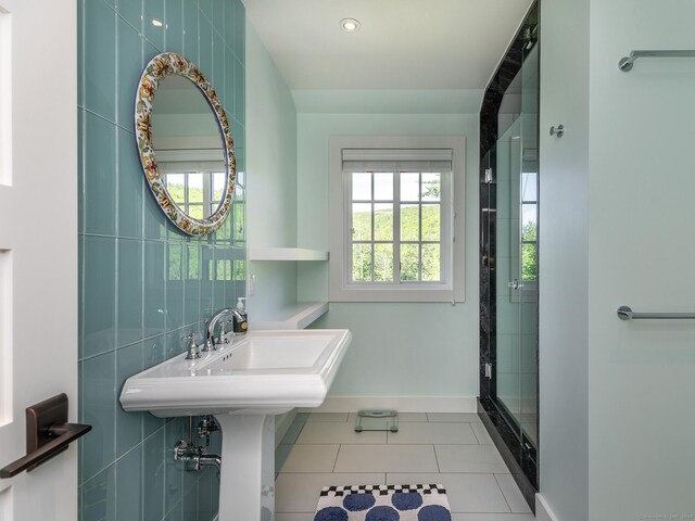 bathroom featuring tile walls, tile patterned flooring, and an enclosed shower