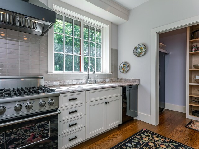 kitchen featuring ventilation hood, light stone counters, white cabinetry, stainless steel range, and dark hardwood / wood-style floors