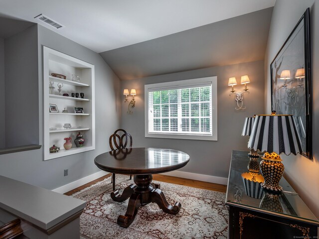 interior space featuring vaulted ceiling and hardwood / wood-style flooring