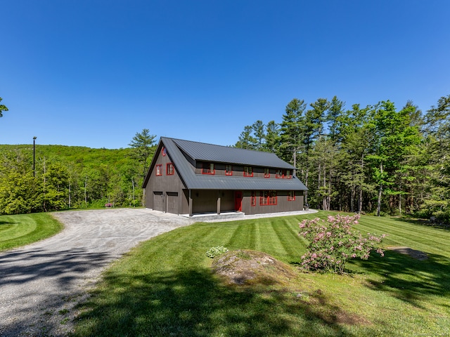 view of front facade with an outbuilding, a front yard, and a garage