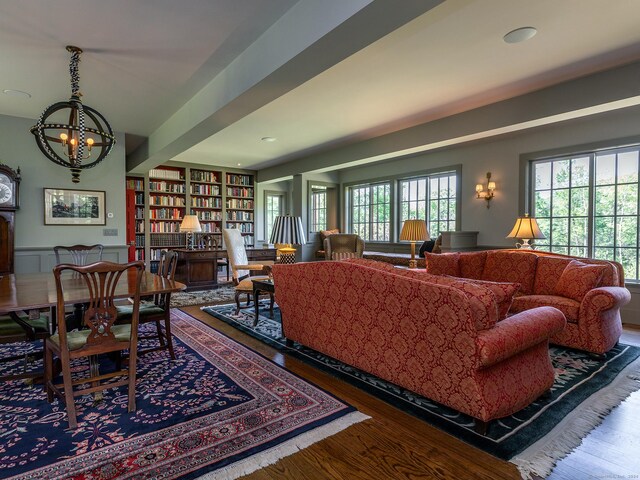 living room with wood-type flooring and an inviting chandelier