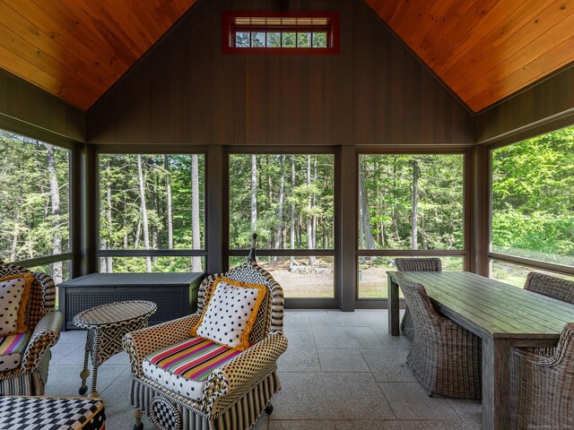 sunroom / solarium with vaulted ceiling and a healthy amount of sunlight