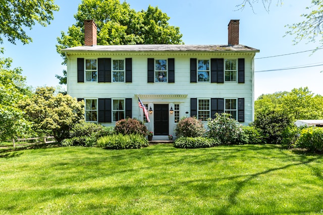 colonial inspired home featuring a front yard