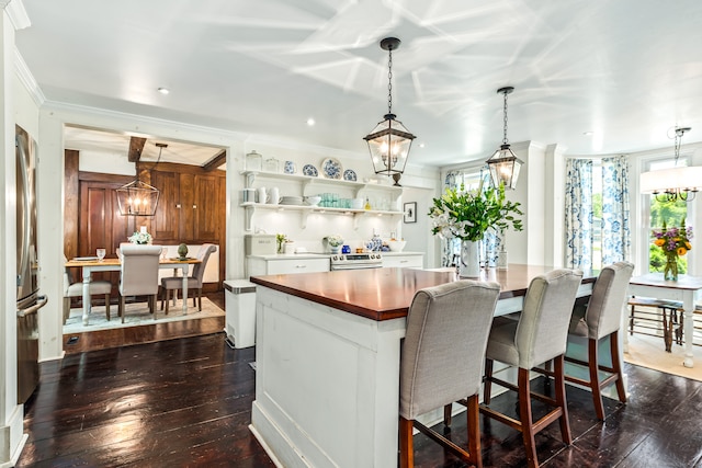 kitchen featuring dark hardwood / wood-style flooring, hanging light fixtures, and a center island