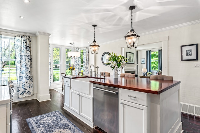 kitchen featuring white cabinetry, hanging light fixtures, a kitchen island with sink, dark wood-type flooring, and dishwasher