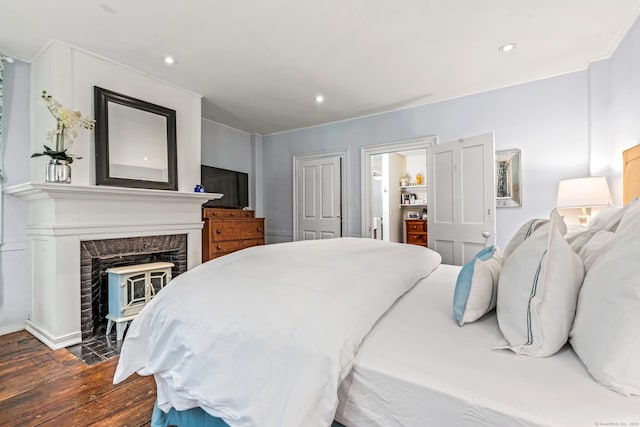 402 Perrin Rd, Woodstock, CT 06281 - bedroom with dark wood finished floors, recessed lighting, and a fireplace