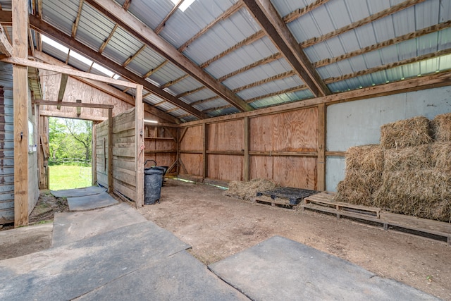 miscellaneous room with vaulted ceiling with beams