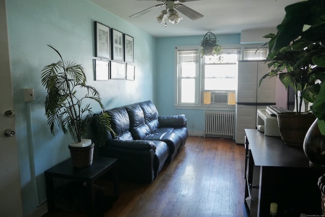 living room featuring cooling unit, radiator, dark hardwood / wood-style flooring, and ceiling fan