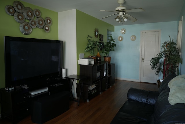 living room with wood finished floors, ceiling fan, and baseboards