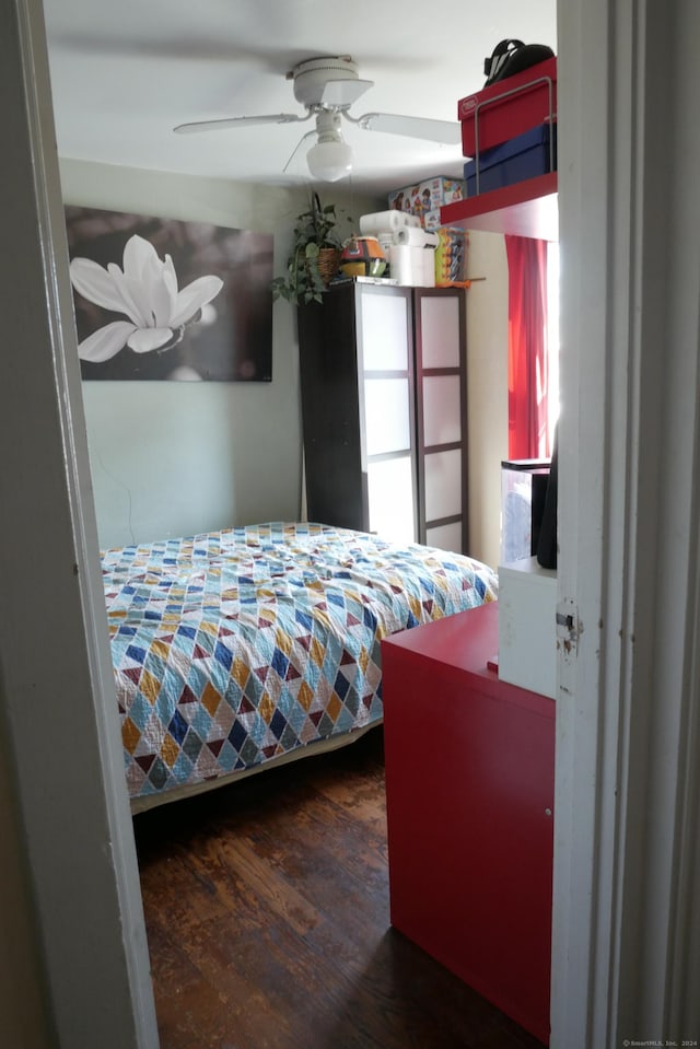 bedroom featuring a ceiling fan and wood finished floors
