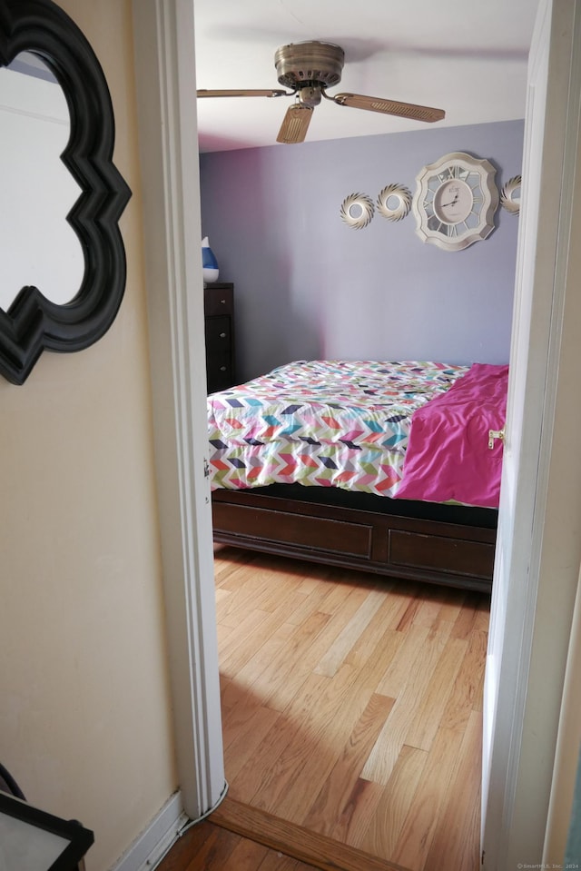 bedroom with ceiling fan and wood finished floors
