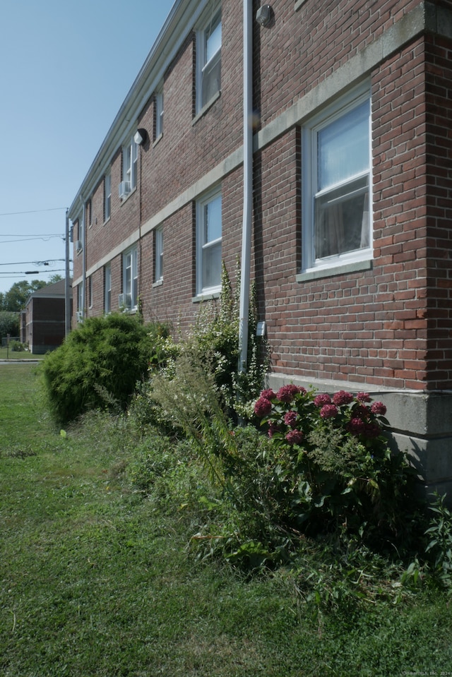 view of side of home featuring a yard