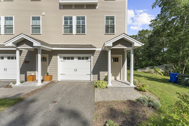 30 Village Xing Unit 30, East Lyme, CT 06357 - view of front of property with a garage, a front lawn, driveway, and a shingled roof