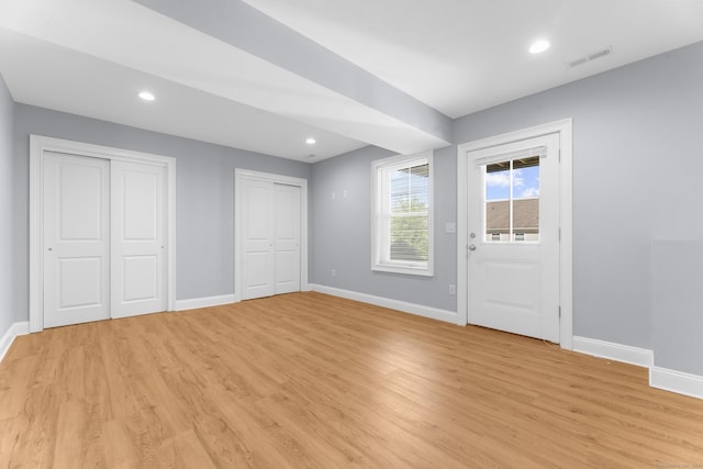 30 Village Xing Unit 30, East Lyme, CT 06357 - unfurnished bedroom featuring light wood finished floors, two closets, and recessed lighting