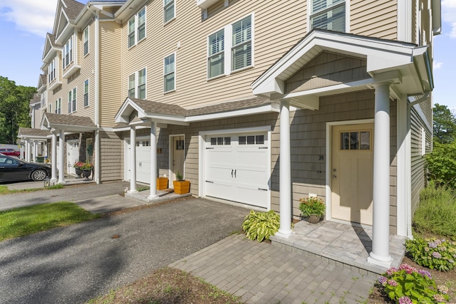 30 Village Xing Unit 30, East Lyme, CT 06357 - view of front of home with a garage and driveway