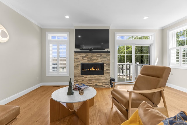30 Village Xing Unit 30, East Lyme, CT 06357 - living area with crown molding, light wood-style flooring, a stone fireplace, and recessed lighting