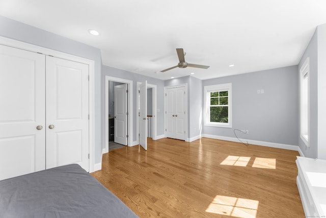 30 Village Xing Unit 30, East Lyme, CT 06357 - unfurnished bedroom with multiple closets, light wood finished floors, recessed lighting, and ceiling fan