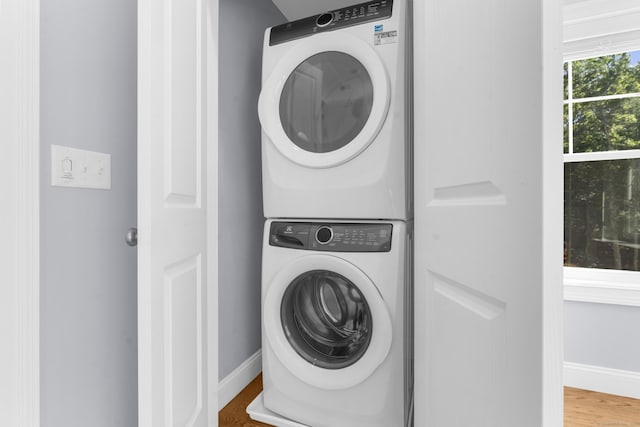 30 Village Xing Unit 30, East Lyme, CT 06357 - laundry area with stacked washer and clothes dryer and wood finished floors